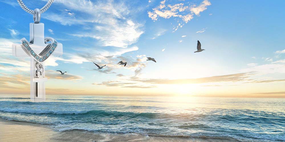A beautiful beach sunrise with a cremation urn necklace on the side