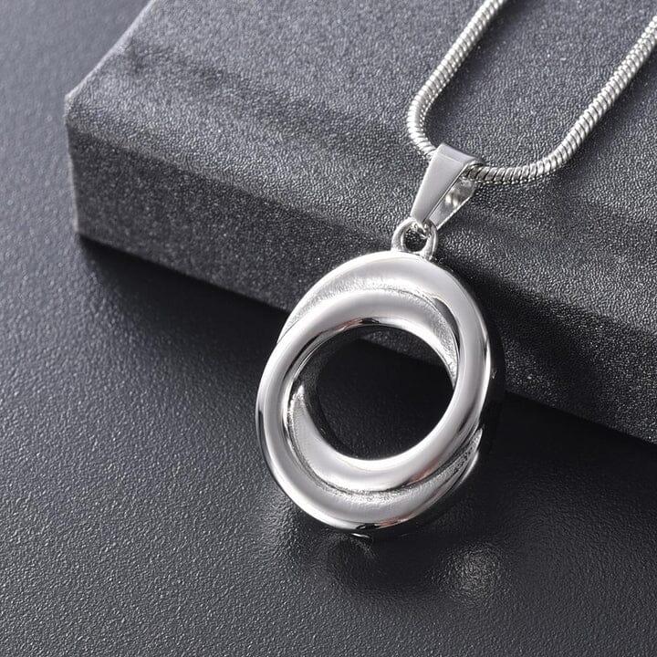 A cremation jewelry necklace that holds a small amount of ash inside