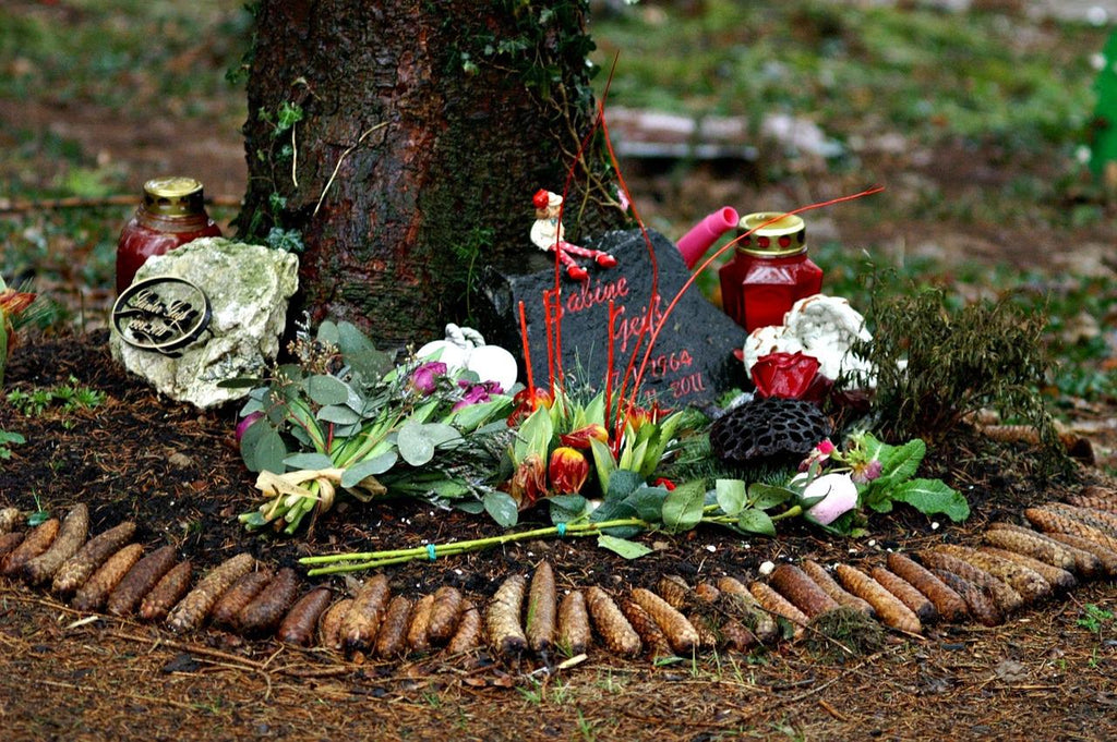 A memorial placed under a tree where a loved one is buried. A way to honor someone and a way to use their ashes after cremation