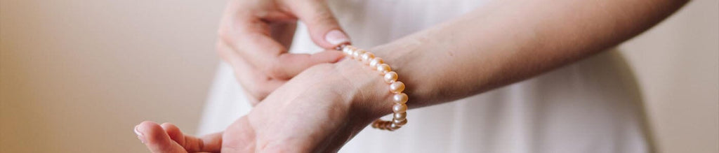 Woman putting on a cremation bracelet holding the ashes of her loved one