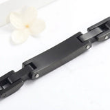 Black stainless steel chain-link cremation bracelet, back view showing blank engraving plate for custom personalization