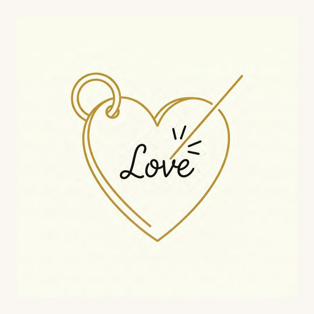 Heart pendant with Love engraved in script and a laser beam marking the engraving