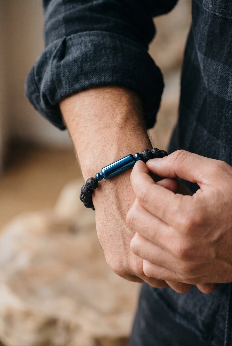 Man wearing a black lava stone cremation bracelet with a blue ash chamber