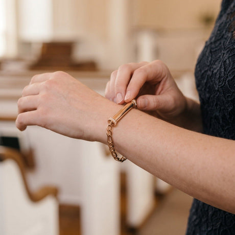 Woman wearing a rose gold classic cremation bracelet with a cylinder ash chamber